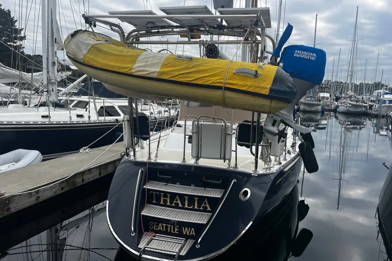 Slide: The Image of Hylas 49 sailboat from 1994 docked in Seattle marina with inflatable dinghy. - 36