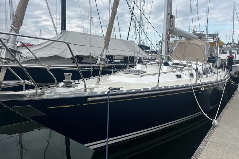 Slide: The Image of Sailboat docked at marina, 1994 Hylas 49 model, sleek design, overcast sky. - 33