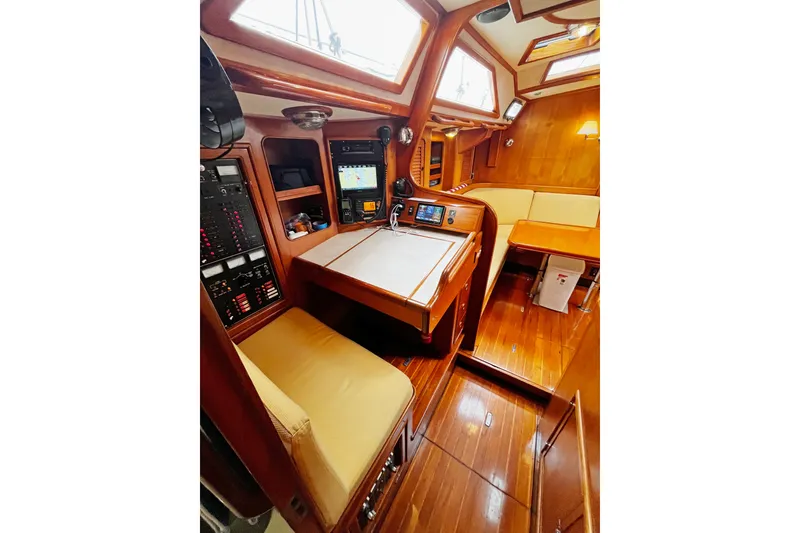 Slide: The Image of Luxurious interior of a 1994 Hylas 49 yacht with wood finish and navigation station. - 16