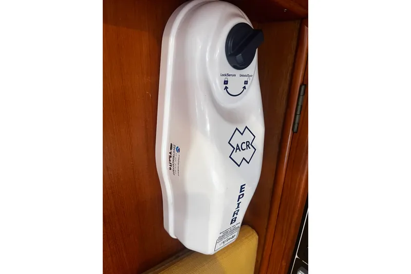 Slide: The Image of ACR EPIRB mounted on a wooden panel inside a 1994 Hylas 49 yacht. - 26