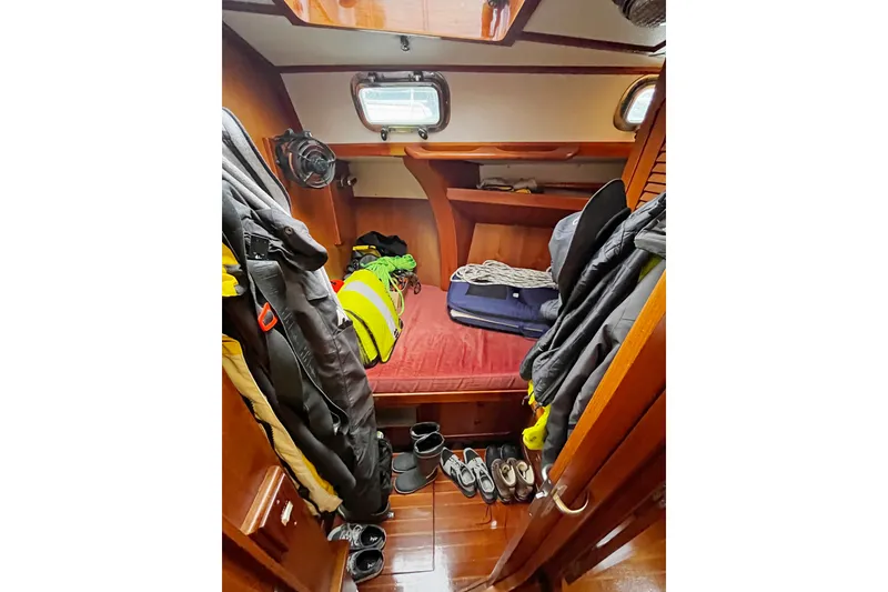 Slide: The Image of Cozy cabin interior of a 1994 Hylas 49 yacht with jackets and shoes. - 20