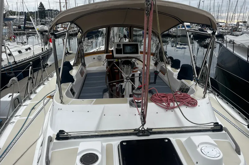 Slide: The Image of 1994 Hylas 49 sailboat docked at marina, featuring spacious cockpit and navigation equipment. - 58