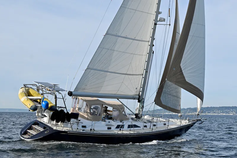 Slide: The Image of Sailing yacht Hylas 49 from 1994 gliding on open water with full sails. - 65
