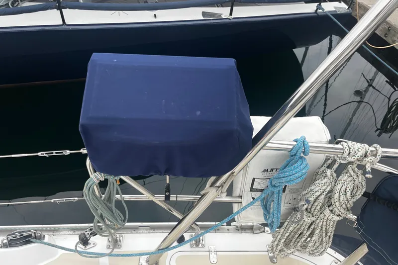 Slide: The Image of Sailboat deck of a 1994 Hylas 49 with covered equipment and coiled ropes. - 63