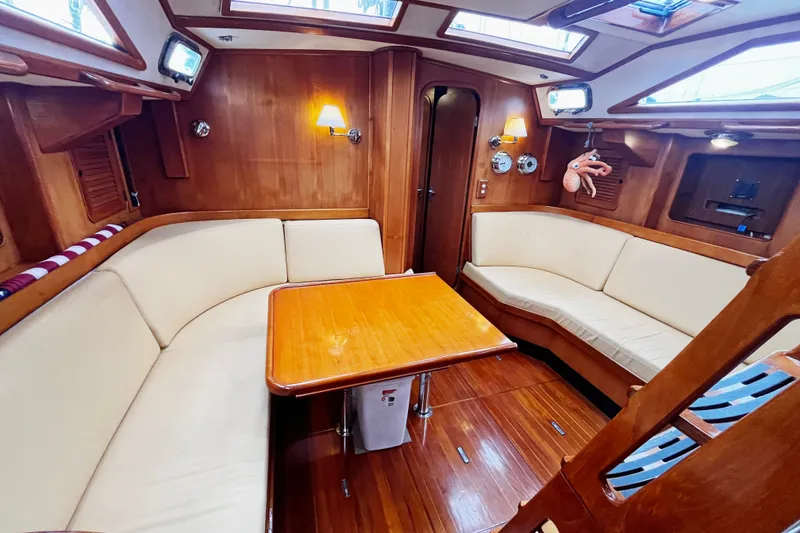 Slide: The Image of Luxurious 1994 Hylas 49 yacht interior with elegant wood finish and cozy seating area. - 6