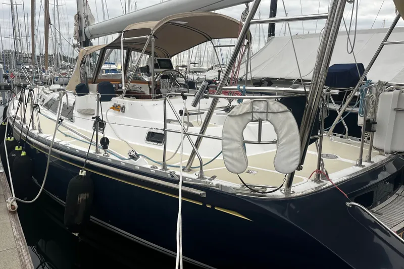 Slide: The Image of Sailboat docked at marina, 1994 Hylas 49 model, featuring sleek design and spacious deck. - 35