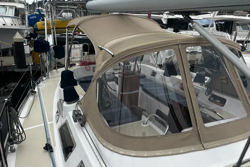 Slide: The Image of 1994 Hylas 49 sailboat with beige canopy docked at marina. - 46