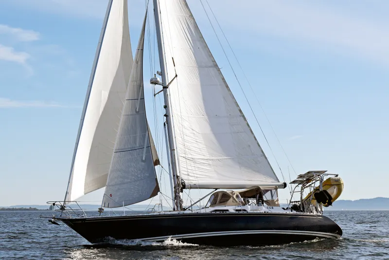 Slide: The Image of Sailing yacht Hylas 49 from 1994 gliding on open water under clear skies. - 66