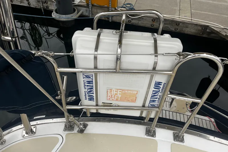 Slide: The Image of Liferaft secured on a 1994 Hylas 49 yacht, docked at a marina. - 62