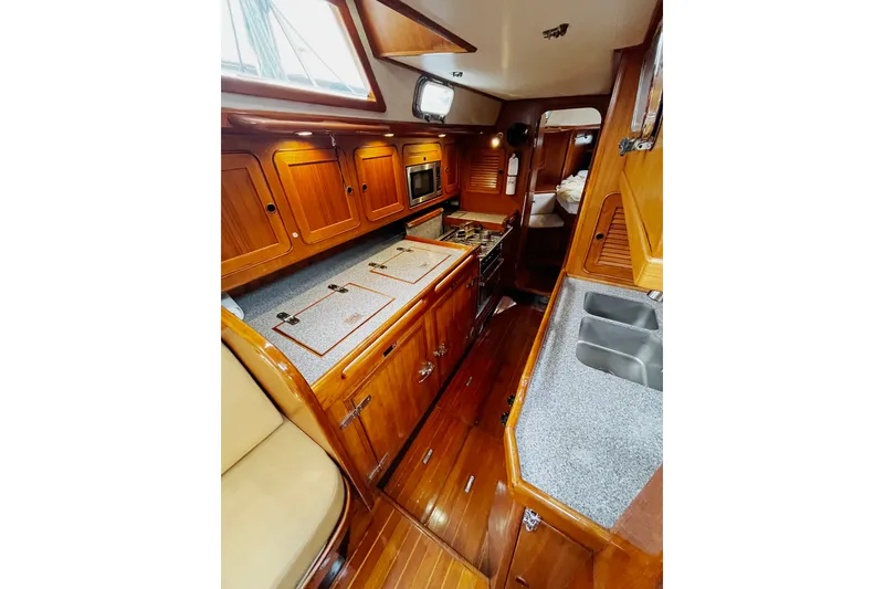 Slide: The Image of Luxurious wooden interior of 1994 Hylas 49 yacht galley with modern amenities. - 9