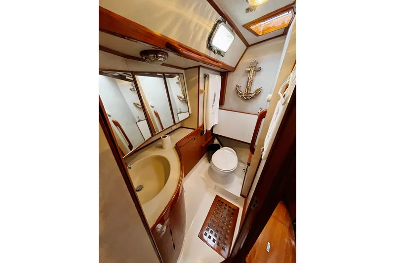 Slide: The Image of Luxurious 1994 Hylas 49 yacht bathroom with wooden accents and nautical decor. - 19