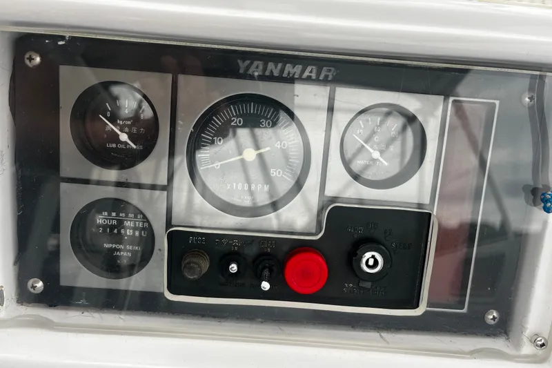 Slide: The Image of Yanmar engine control panel on a 1994 Hylas 49 sailboat, featuring gauges and switches. - 53