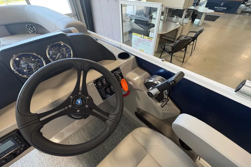 Slide: The Image of Steering console of 2027 Premier 220 Sunscape RL - DL boat, featuring modern controls and gauges. - 13