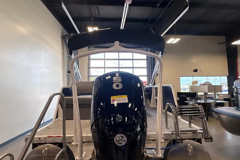 Slide: The Image of 2027 Premier 220 Sunscape RL - DL pontoon boat in showroom, rear view with motor. - 4