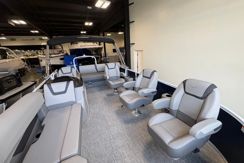 Slide: The Image of 2027 Premier 220 Sunscape RL - DL pontoon boat interior with luxurious seating in showroom. - 5