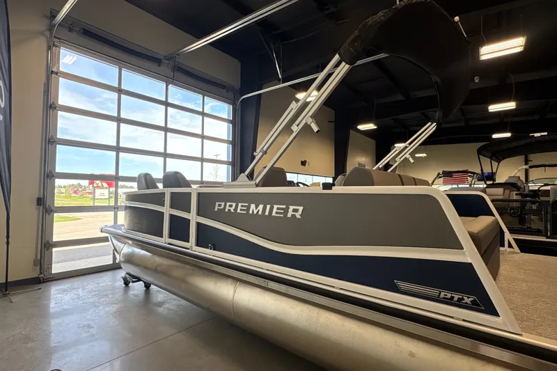 Slide: The Image of 2027 Premier 220 Sunscape RL - DL pontoon boat displayed indoors. - 2