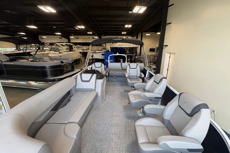 Slide: The Image of 2027 Premier 220 Sunscape RL - DL pontoon boat interior with luxurious seating in showroom. - 6