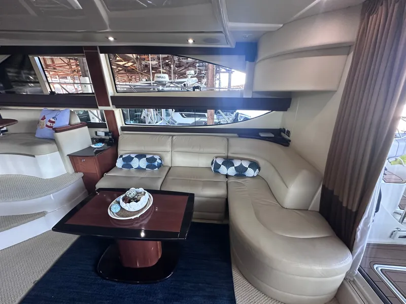 Slide: The Image of Interior of a 2009 Meridian 391 Sedan with beige leather sofa and wooden table. - 42