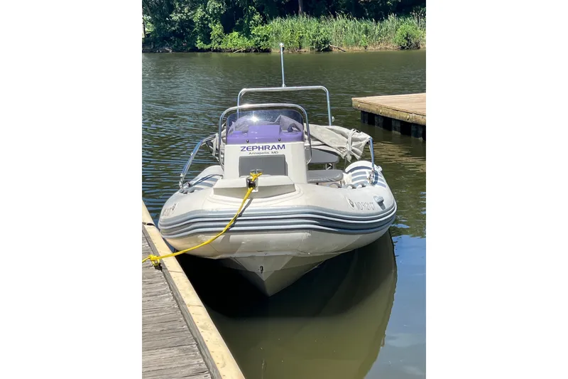 The Image of 2019 Brig Navigator 485 boat docked on calm water, featuring sleek design and sturdy build. - 6
