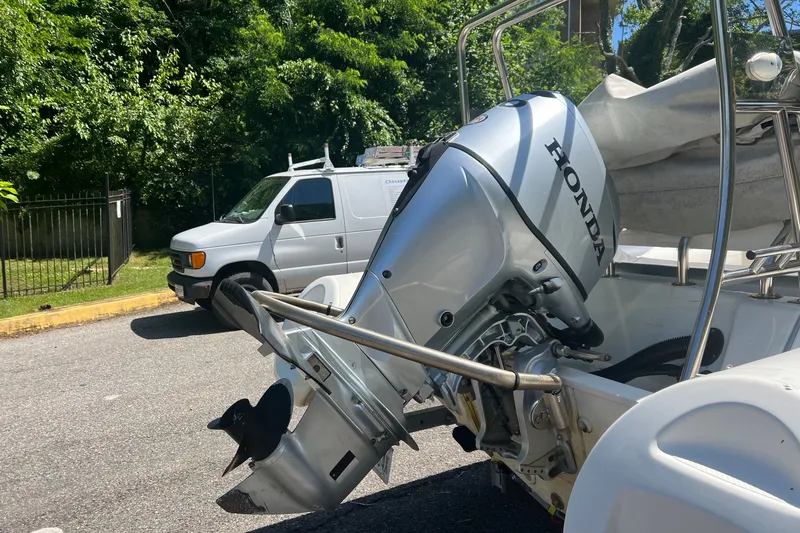 Slide: The Image of 2019 Brig Navigator 485 boat with Honda outboard motor, parked near a white van. - 20