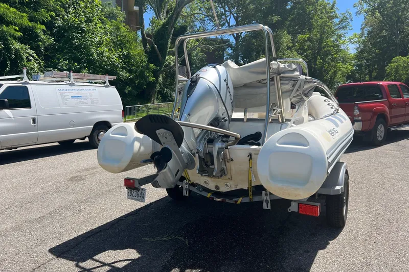 Slide: The Image of 2019 Brig Navigator 485 inflatable boat on trailer, parked on a sunny street. - 19