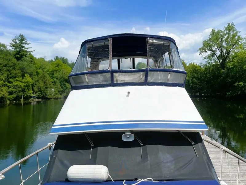 Slide: The Image of A 1987 Bestway Labelle 40 docked at a serene, wooded shoreline. - 18