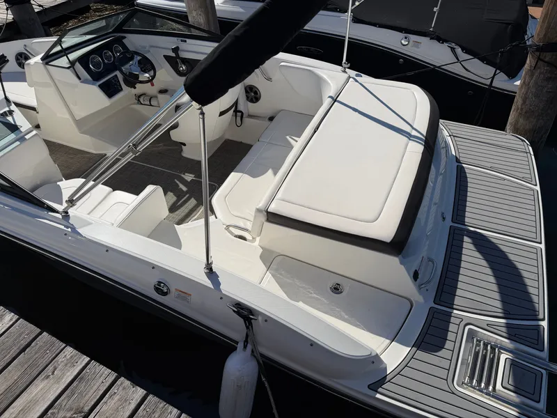 Slide: The Image of The image shows a 2019 Sea Ray 190 Sport boat with white seating and a gray deck. - 4