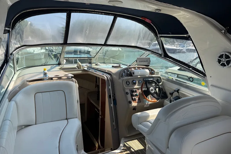 Slide: The Image of Interior of a 2001 Sea Ray 290 Sundancer boat with steering wheel and seating. - 9