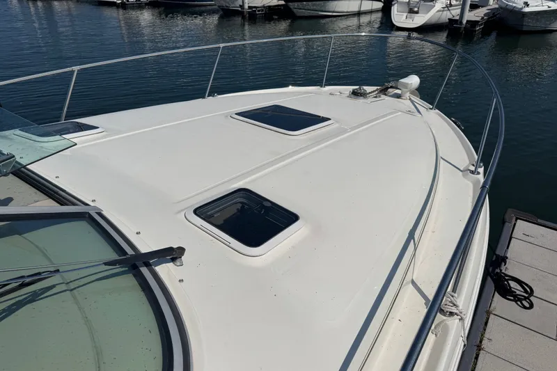 Slide: The Image of 2001 Sea Ray 290 Sundancer boat deck with hatches, docked in marina. - 3