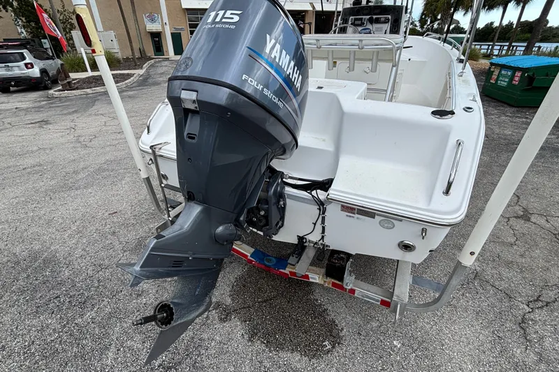 Slide: The Image of 2006 Sea Hunt Triton 186 boat with Yamaha 115 four-stroke engine, parked on a trailer. - 2