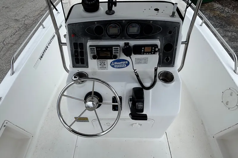 Slide: The Image of 2006 Sea Hunt Triton 186 boat console with steering wheel and navigation controls. - 6