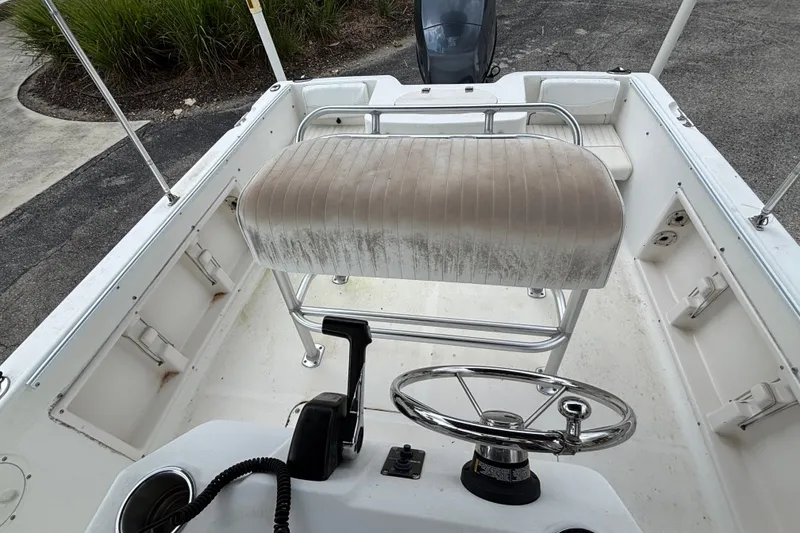 Slide: The Image of 2006 Sea Hunt Triton 186 boat interior with steering wheel and seating. - 9