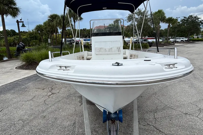 Slide: The Image of 2006 Sea Hunt Triton 186 boat on trailer, parked outdoors with palm trees. - 4