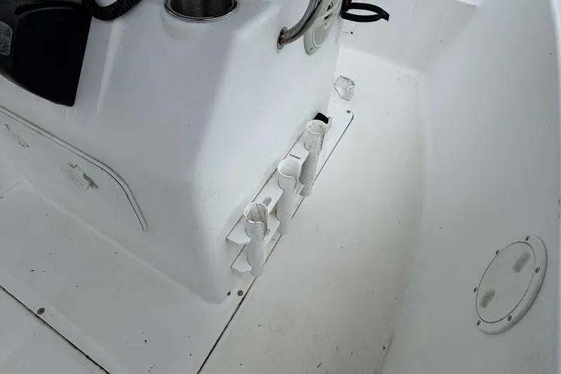 Slide: The Image of 2006 Sea Hunt Triton 186 boat interior with rod holders and storage compartments. - 7