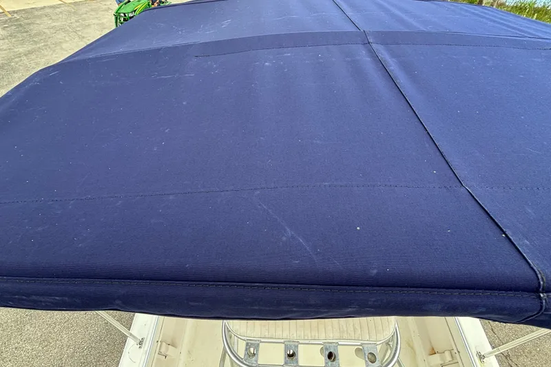 Slide: The Image of Blue canvas top of a 2006 Sea Hunt Triton 186 boat. - 12