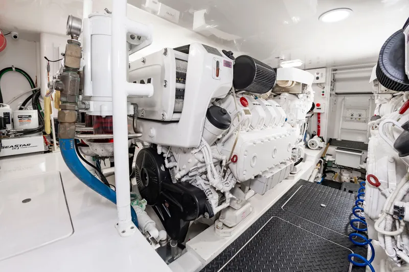 Slide: The Image of The engine room of a 2018 Viking Sport Tower with a large white engine and technical equipment. - 41