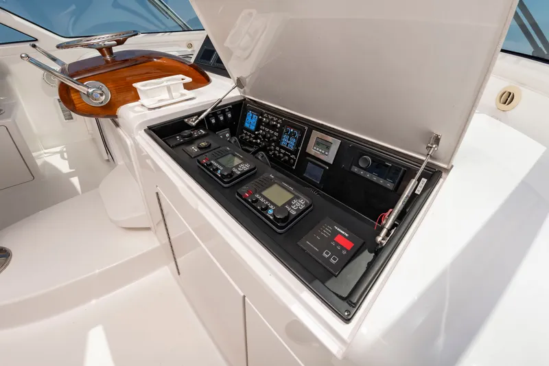 Slide: The Image of The image shows the helm of a 2018 Viking Sport Tower yacht with modern instruments. - 18