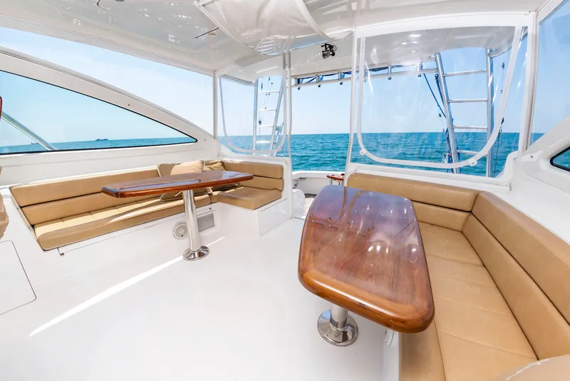 Slide: The Image of The image shows the interior of a 2018 Viking Sport Tower with beige seating and wooden tables. - 16