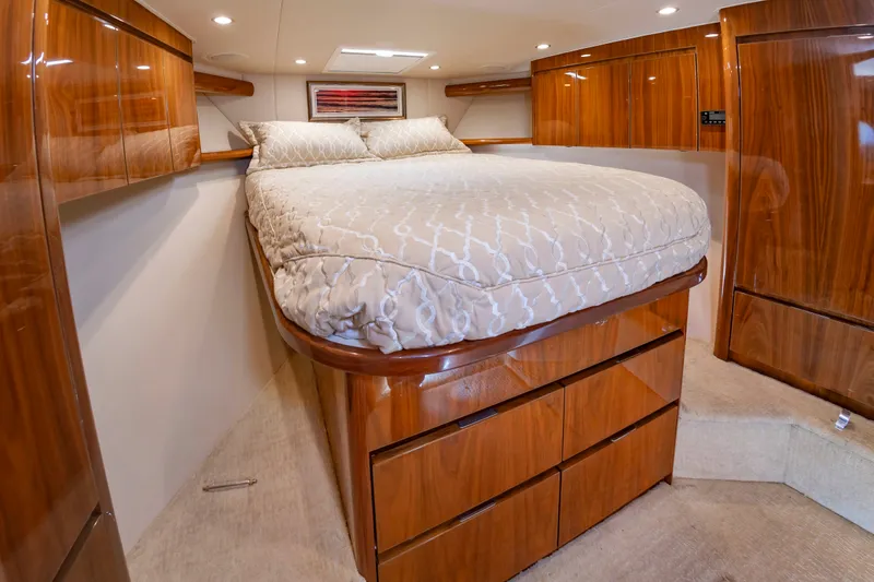 Slide: The Image of The image shows a luxurious cabin with a large bed and elegant wooden cabinets. - 36