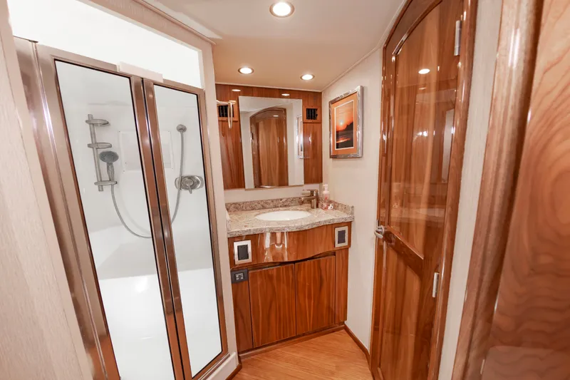 Slide: The Image of Luxurious bathroom with wood paneling, shower, and sink in a 2018 Viking Sport Tower. - 39