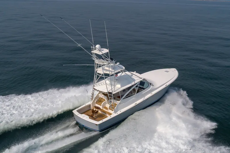 Slide: The Image of A 2018 Viking Sport Tower speeds across the sea, featuring a clear bow view and fishing rods. - 6