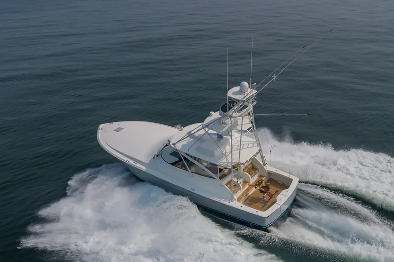 Slide: The Image of A sleek, white sport boat speeds across calm waters, featuring a spacious deck. - 2