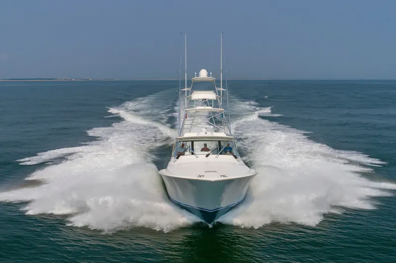 Slide: The Image of A 2018 Viking Sport Tower boat speeds across the water, creating an impressive wake. - 3