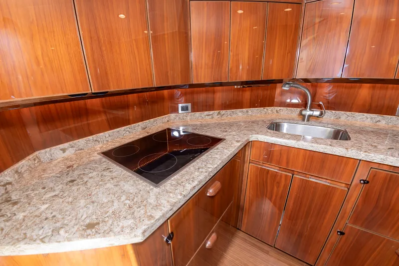 Slide: The Image of The 2018 Viking Sport Tower kitchen features a sleek countertop, cooktop, and sink. - 27