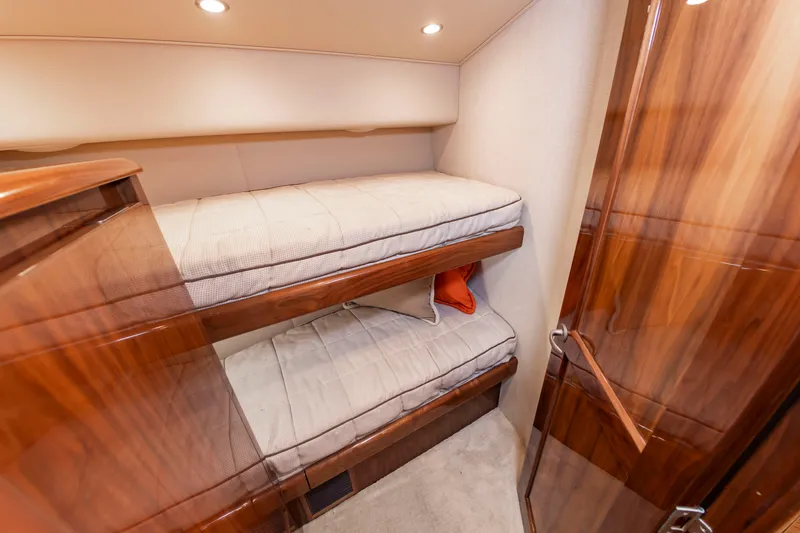Slide: The Image of Interior with two bunk beds and wooden furnishings in a boat. - 34