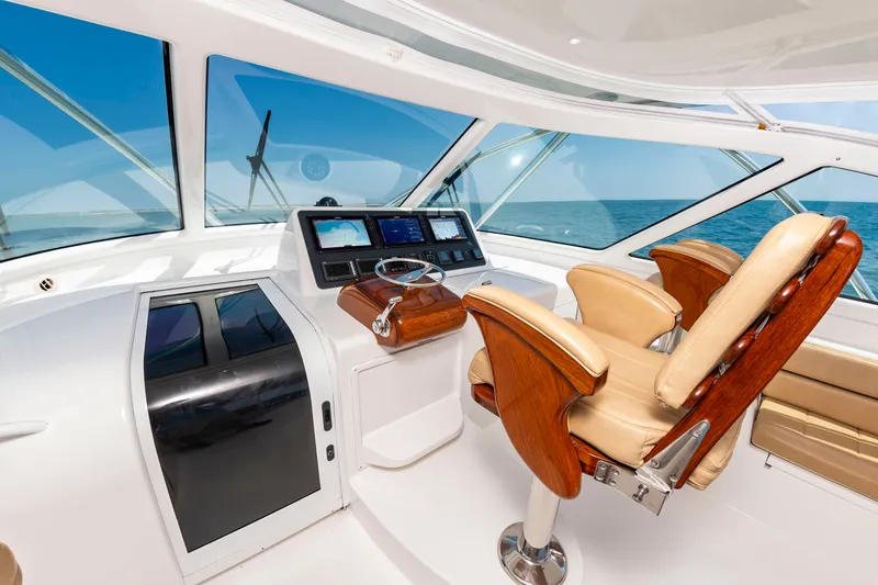 Slide: The Image of The image shows the cockpit of a 2018 Viking Sport Tower yacht with luxurious seating and modern electronics. - 17