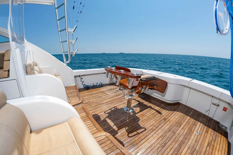 Slide: The Image of 2018 Viking Sport Tower with spacious deck and fishing chair, on open sea under clear skies. - 7