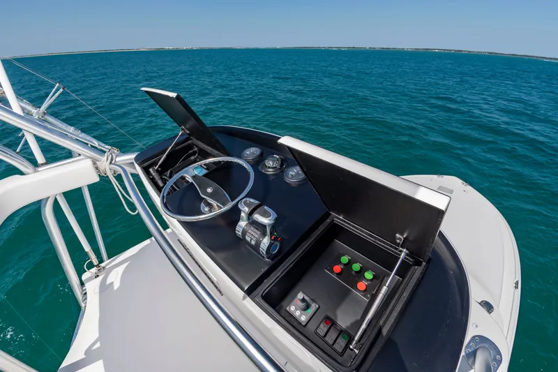 Slide: The Image of The image shows the helm of a 2018 Viking Sport Tower yacht on open water. - 23