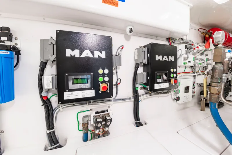Slide: The Image of The engine room of a 2018 Viking Sport Tower with MAN controls and wiring. - 47