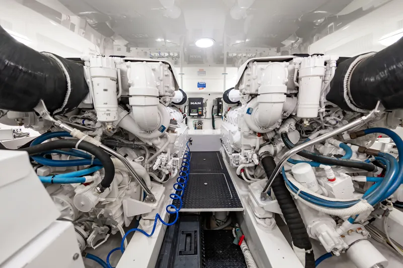 Slide: The Image of The engine room of a 2018 Viking Sport Tower with two large engines and blue hoses. - 40